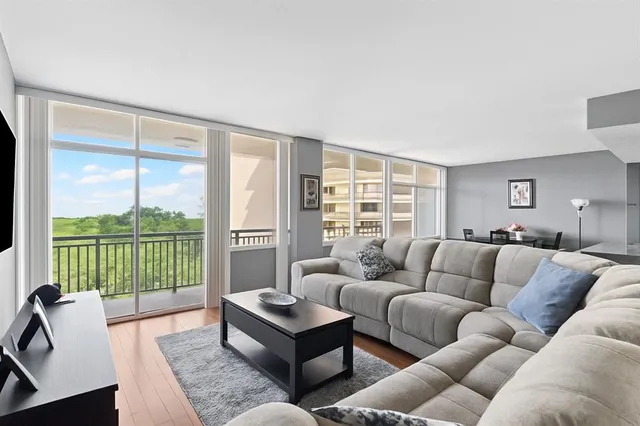 a living room with furniture and a floor to ceiling window