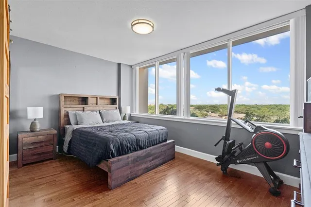 a bedroom with a large bed and a large window