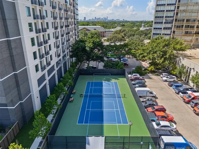 a living room with furniture wooden floor and a large window
