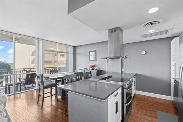 a kitchen with stainless steel appliances granite countertop a sink a stove and a refrigerator