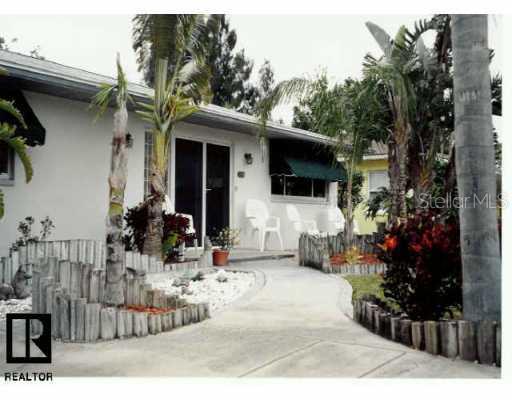 340 12th Avenue Indian Rocks Beach, FL 33785 - Photo 1 of 1 Exterior Front - *Lush Tropical Landscaping*