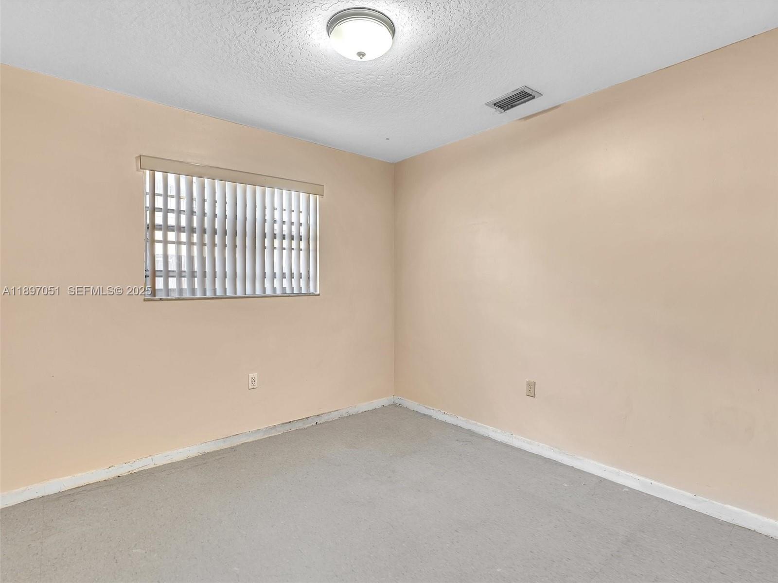 17995 Southwest 105th Avenue Miami, FL 33157 - Photo 22 of 45 an empty room with a window