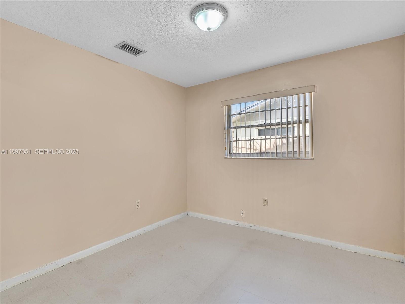 17995 Southwest 105th Avenue Miami, FL 33157 - Photo 24 of 45 an empty room with a window