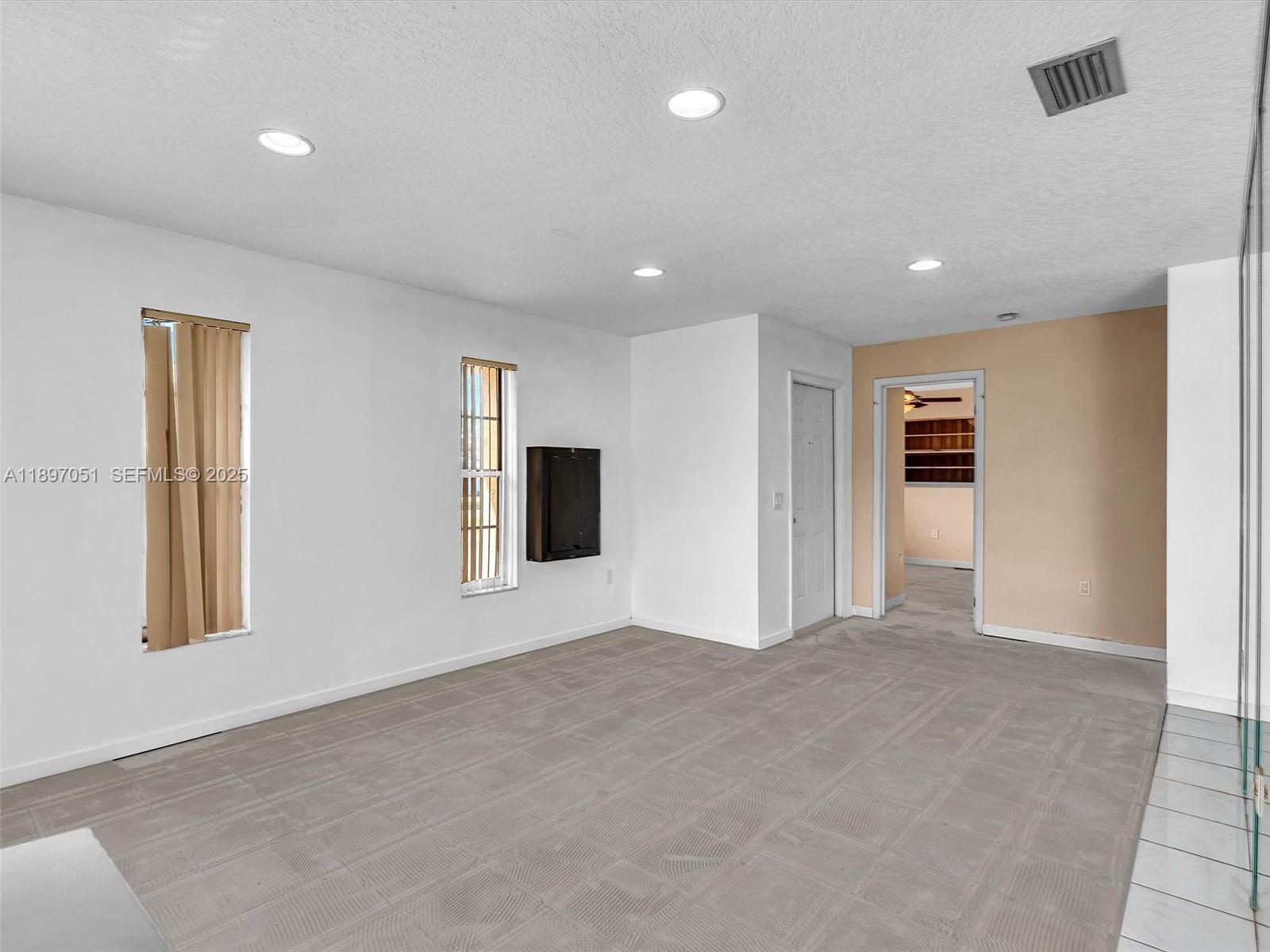 17995 Southwest 105th Avenue Miami, FL 33157 - Photo 38 of 45 a view of a livingroom with an empty space and windows