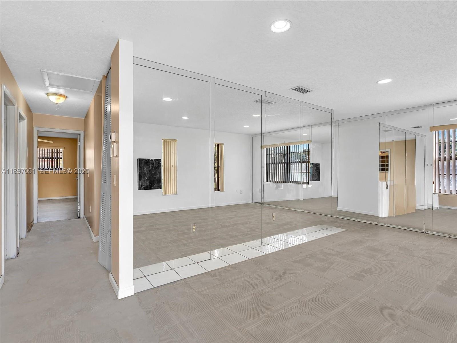 17995 Southwest 105th Avenue Miami, FL 33157 - Photo 42 of 45 a view of an empty room with kitchen and chandelier