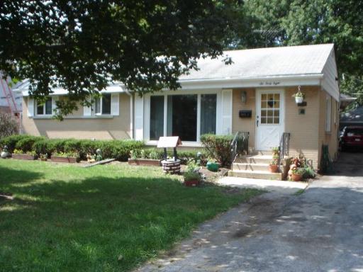648 Shermer Road Glenview, IL 60025 - Photo 1 of 1 a front view of a house with swing and chairs