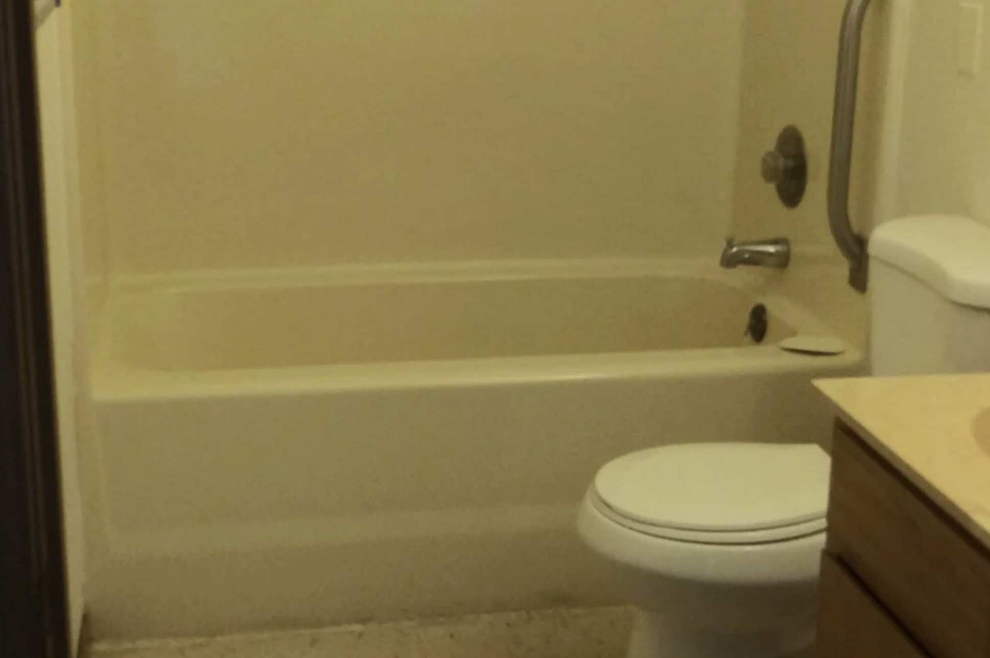 233 High Street Butler, IN 46721 - Photo 11 of 16 a white toilet sitting next to a bath tub
