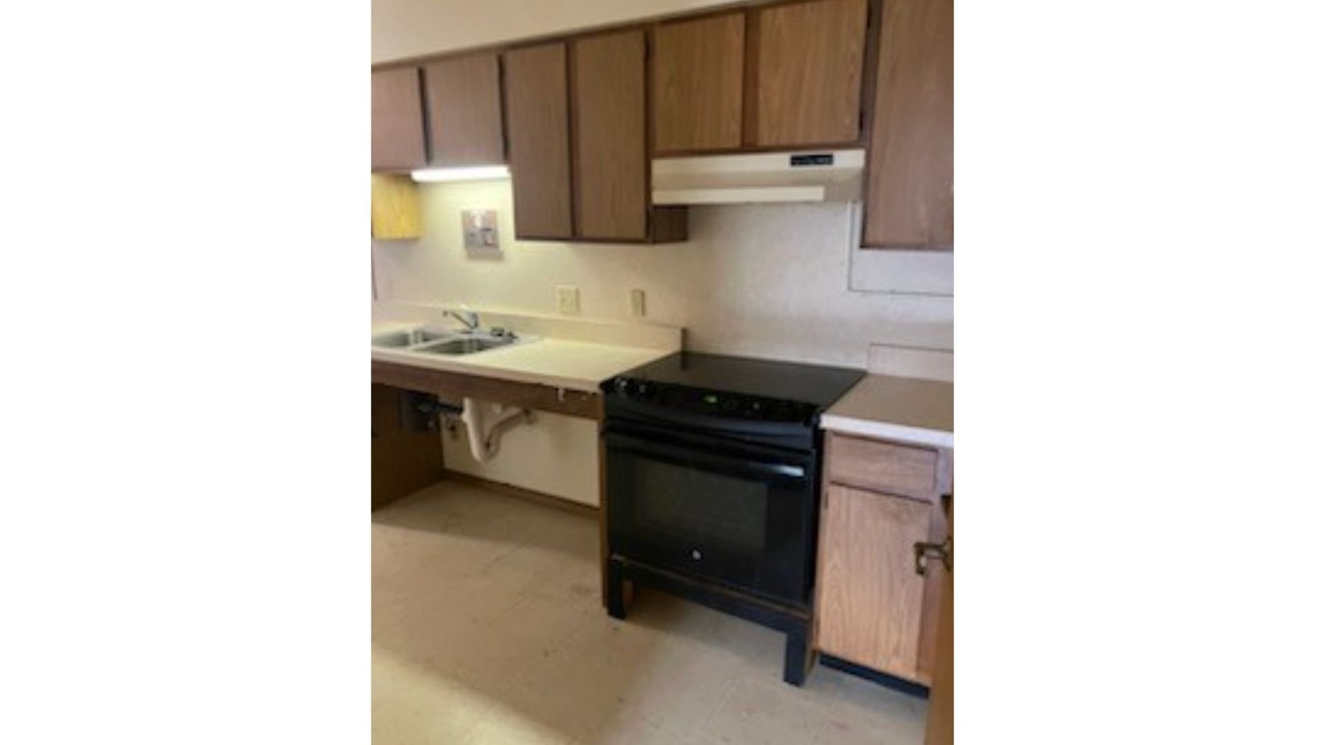 233 High Street Butler, IN 46721 - Photo 14 of 16 a kitchen with a sink and a stove