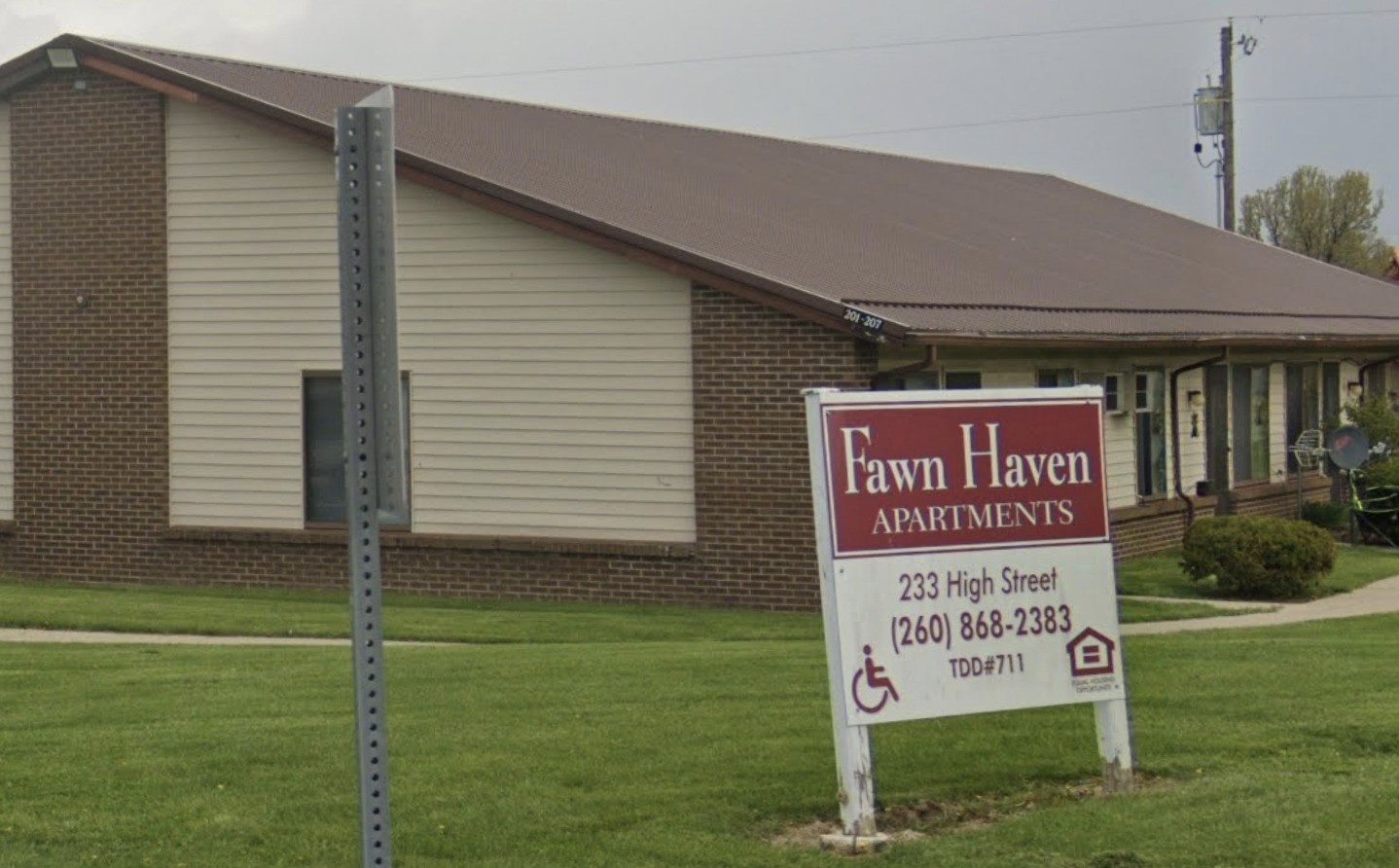 233 High Street Butler, IN 46721 - Photo 3 of 16 a sign on the side of the house