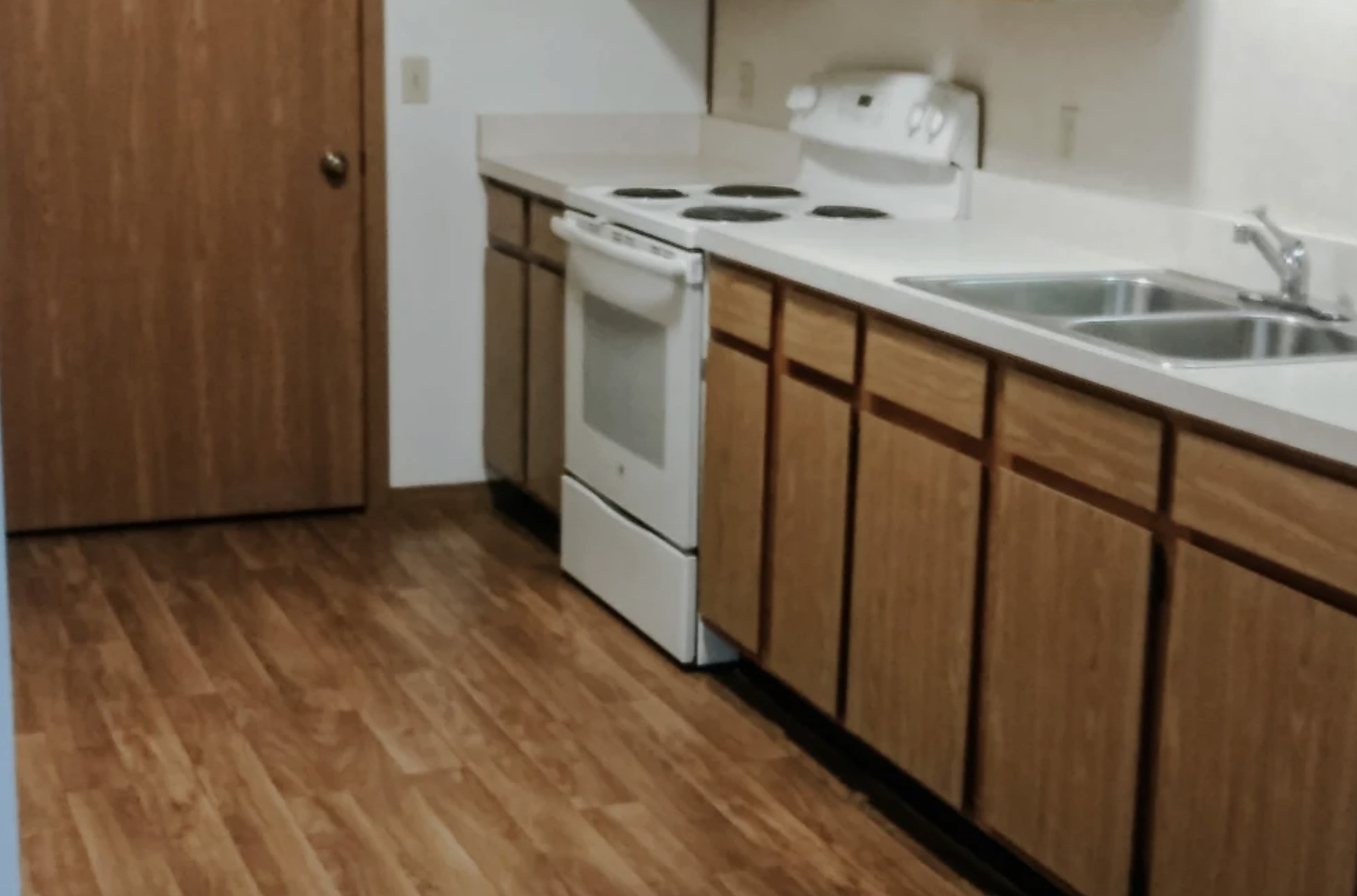 233 High Street Butler, IN 46721 - Photo 10 of 16 a kitchen with a stove and wooden floor