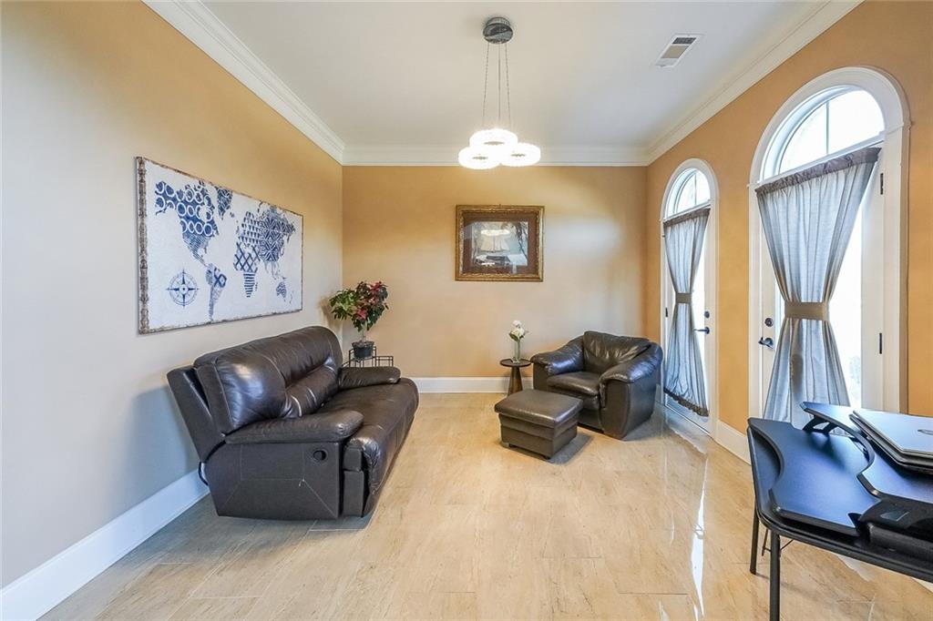 2425 Wild Oak Court Stockbridge, GA 30281 - Photo 12 of 32 a living room with furniture a chandelier and a painting