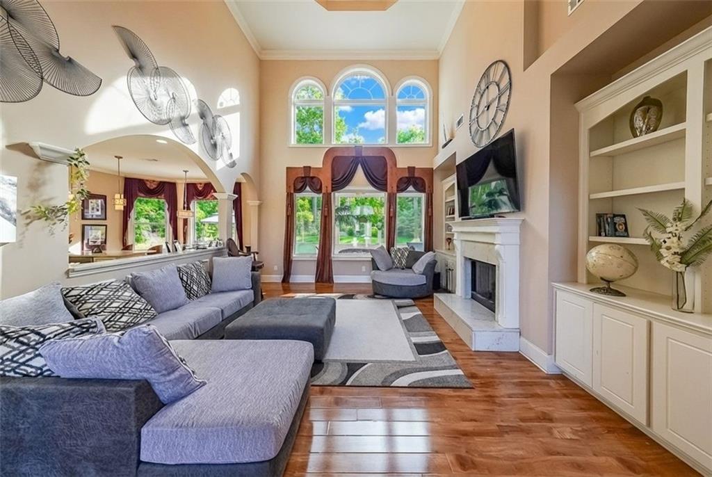 2425 Wild Oak Court Stockbridge, GA 30281 - Photo 13 of 39 a living room with furniture a fireplace and a chandelier