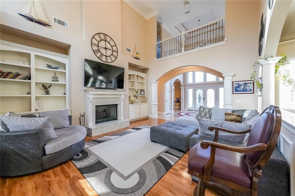 2425 Wild Oak Court Stockbridge, GA 30281 - Photo 14 of 39 a living room with furniture a fireplace and a flat screen tv