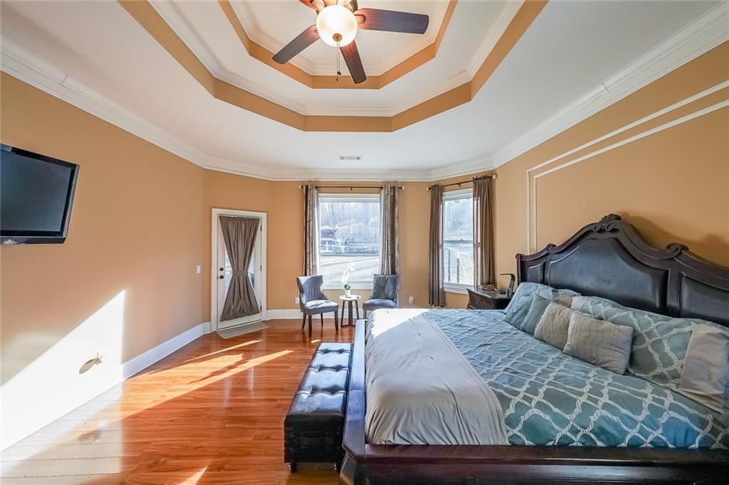 2425 Wild Oak Court Stockbridge, GA 30281 - Photo 15 of 32 a bedroom with a bed and wooden floor