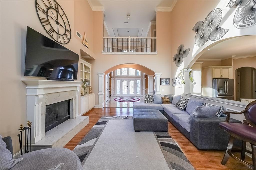 2425 Wild Oak Court Stockbridge, GA 30281 - Photo 15 of 39 a living room with furniture a fireplace and a flat screen tv
