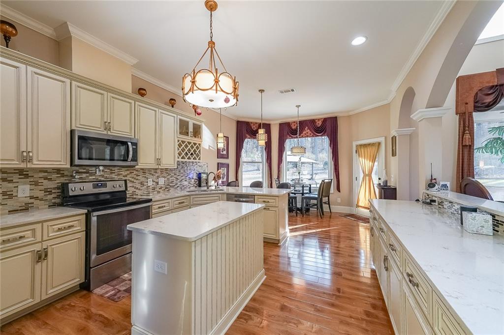 2425 Wild Oak Court Stockbridge, GA 30281 - Photo 20 of 39 a very nice looking kitchen with granite countertop lots of counter space a sink appliances and a large window