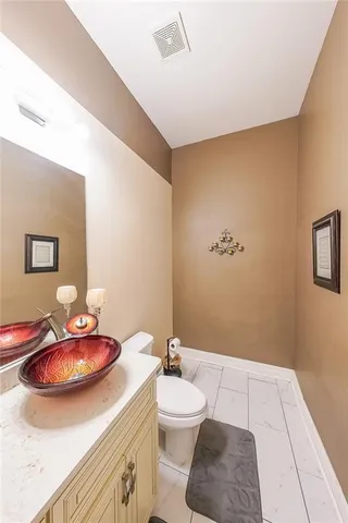 a bathroom with a sink a toilet and mirror