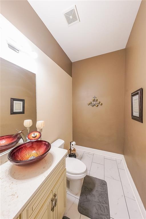 2425 Wild Oak Court Stockbridge, GA 30281 - Photo 23 of 39 a bathroom with a sink a toilet and mirror