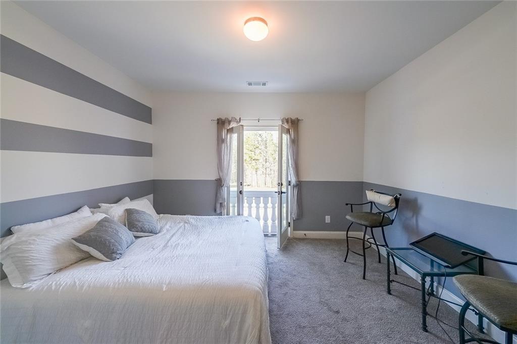 2425 Wild Oak Court Stockbridge, GA 30281 - Photo 30 of 39 a bedroom with a bed and a window