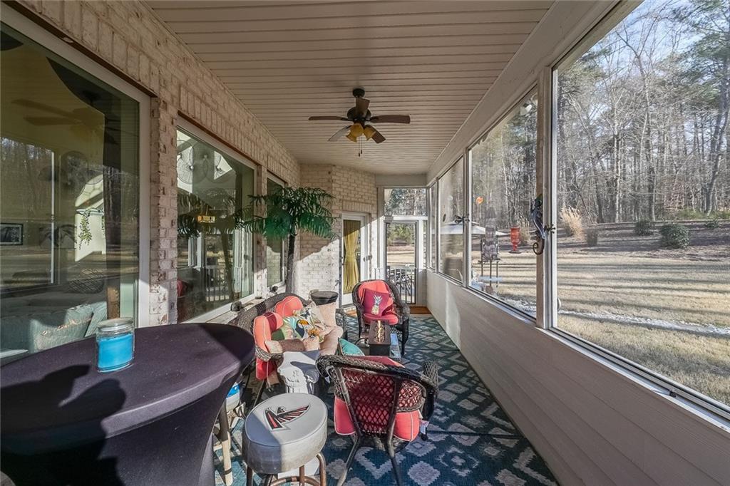 2425 Wild Oak Court Stockbridge, GA 30281 - Photo 33 of 39 a view of a patio with table and chairs potted plants with floor to ceiling window