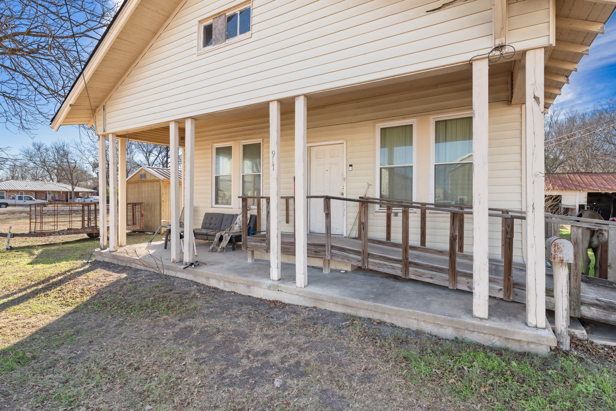 917 Trinity Street Lockhart, TX 78644 - Photo 3 of 13 a view of a house with wooden deck and a floor to ceiling window