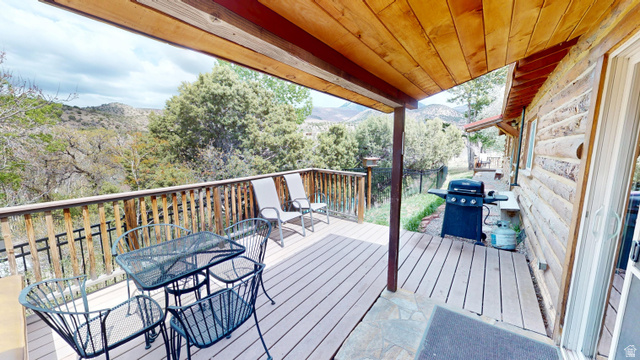 315 Abbey Road Moab, UT 84532 - Photo 37 of 46 Deck featuring a grill, outdoor dining area, and a mountain view