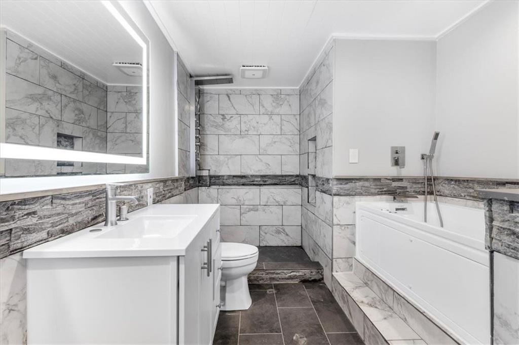 160 Amidon Drive Villa Rica, GA 30180 - Photo 23 of 39 a bathroom with a sink toilet double vanity and tub