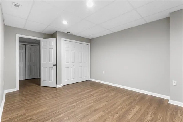 a balcony with wooden floor and fence