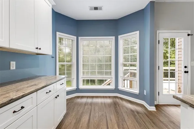 a view of a kitchen with a sink and wooden floor