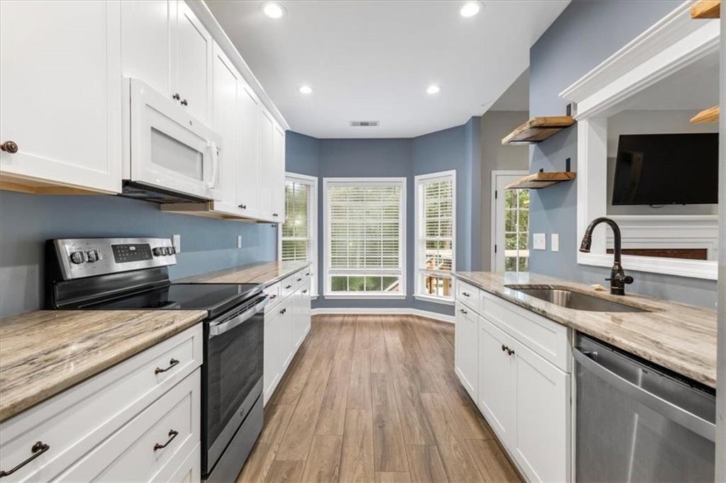 160 Amidon Drive Villa Rica, GA 30180 - Photo 10 of 39 a large kitchen with stainless steel appliances granite countertop a stove sink and microwave