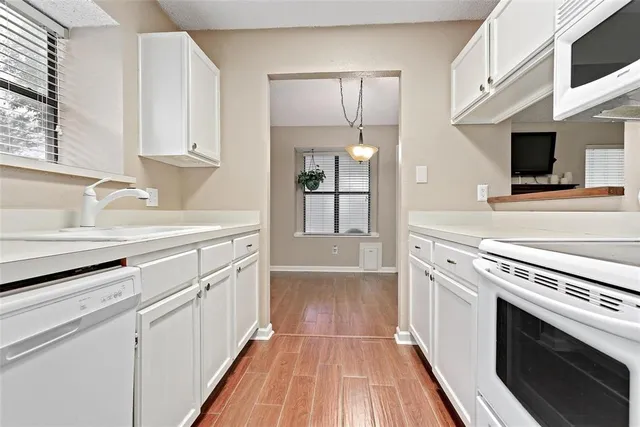 a kitchen with a sink stove and refrigerator