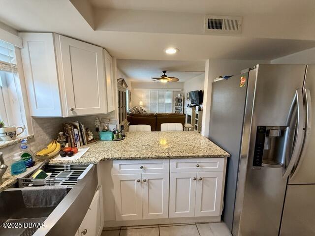 404 South Beach Street, Unit 101 Daytona Beach, FL 32114 - Photo 14 of 35 a kitchen with stainless steel appliances granite countertop a refrigerator and a sink