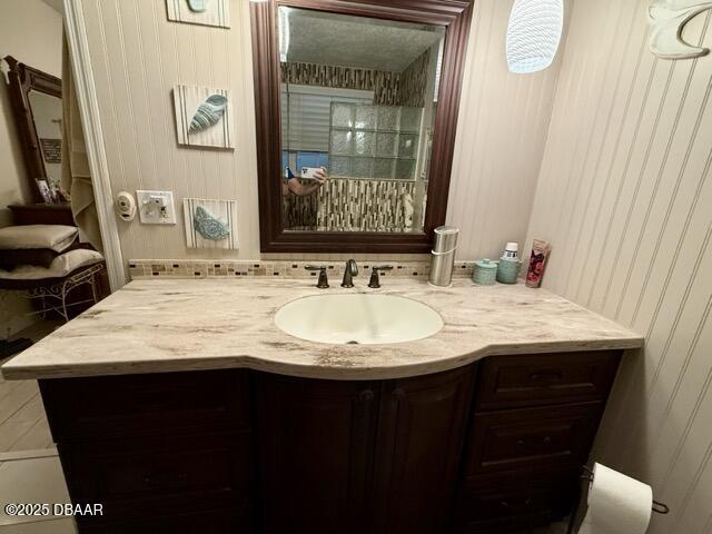 404 South Beach Street, Unit 101 Daytona Beach, FL 32114 - Photo 23 of 35 a bathroom with a granite countertop sink a mirror and a vanity