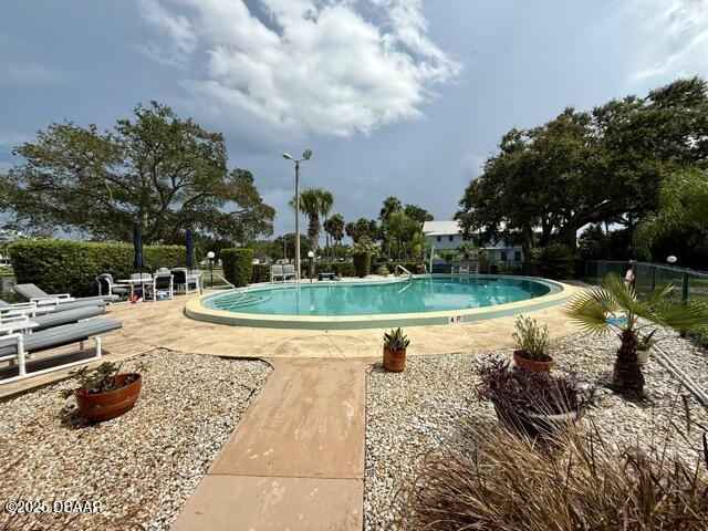 404 South Beach Street, Unit 101 Daytona Beach, FL 32114 - Photo 29 of 35 a view of a swimming pool and a yard