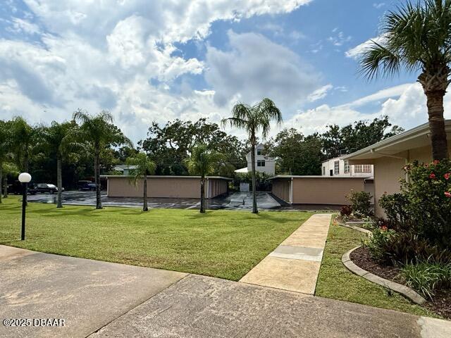 404 South Beach Street, Unit 101 Daytona Beach, FL 32114 - Photo 31 of 35 a swimming pool with lots of trees in the background