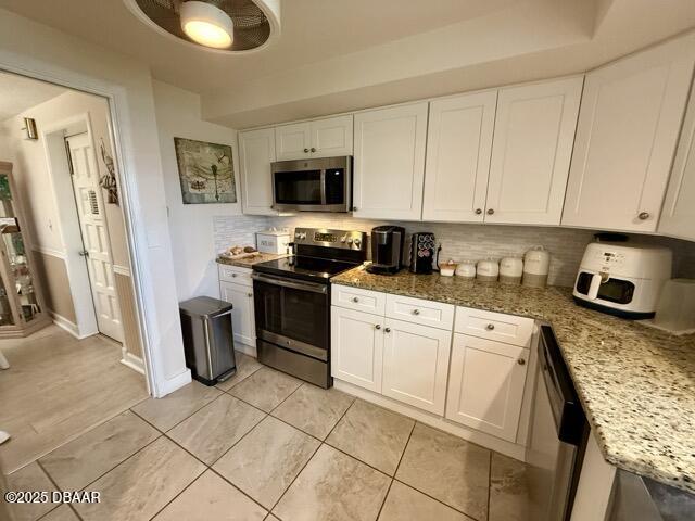 404 South Beach Street, Unit 101 Daytona Beach, FL 32114 - Photo 10 of 35 a kitchen with stainless steel appliances granite countertop a stove a sink dishwasher and a refrigerator