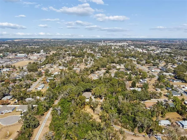 an aerial view of residential building with green space