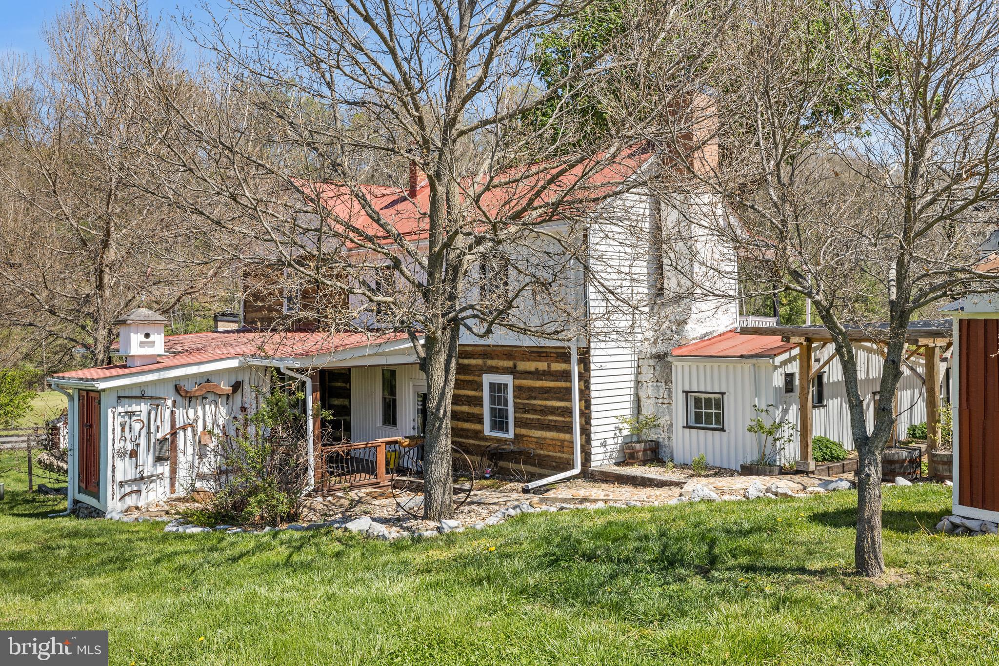 989 Swover Creek Road Edinburg, VA 22824 - Photo 123 of 132 a front view of a house with a yard table and chairs