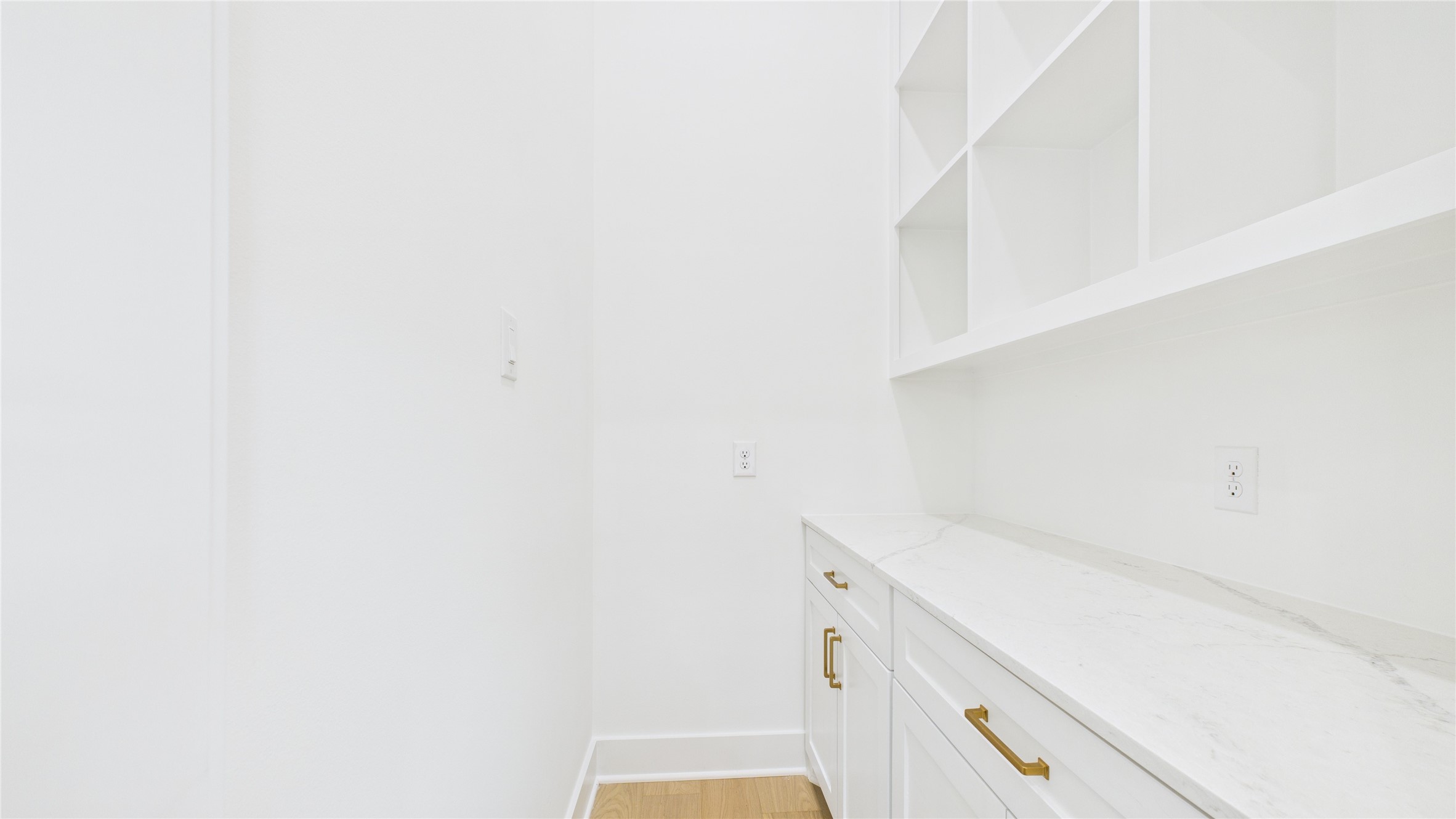 602 Jewett Street, Unit A Houston, TX 77009 - Photo 11 of 46 The butler's pantry features open shelves above, a quartz countertop, and built-ins - providing ample storage and a clean, modern look.