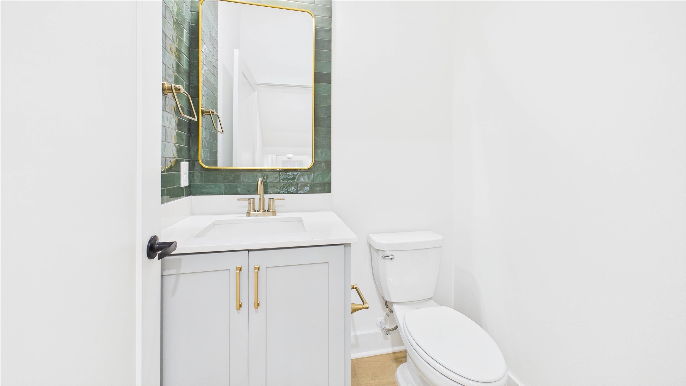 602 Jewett Street, Unit A Houston, TX 77009 - Photo 17 of 46 First floor half bath has sleek finishes and storage.