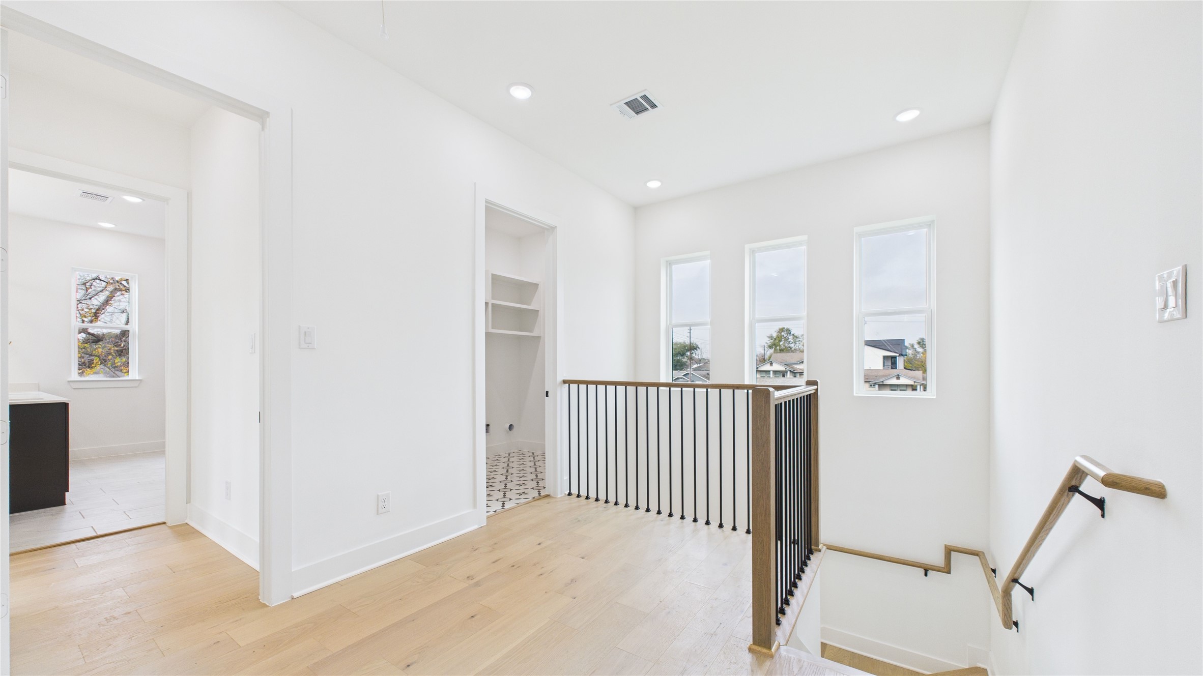 602 Jewett Street, Unit A Houston, TX 77009 - Photo 20 of 46 Airy upper-level landing with three vertical windows providing natural light. Cozy additional living space.