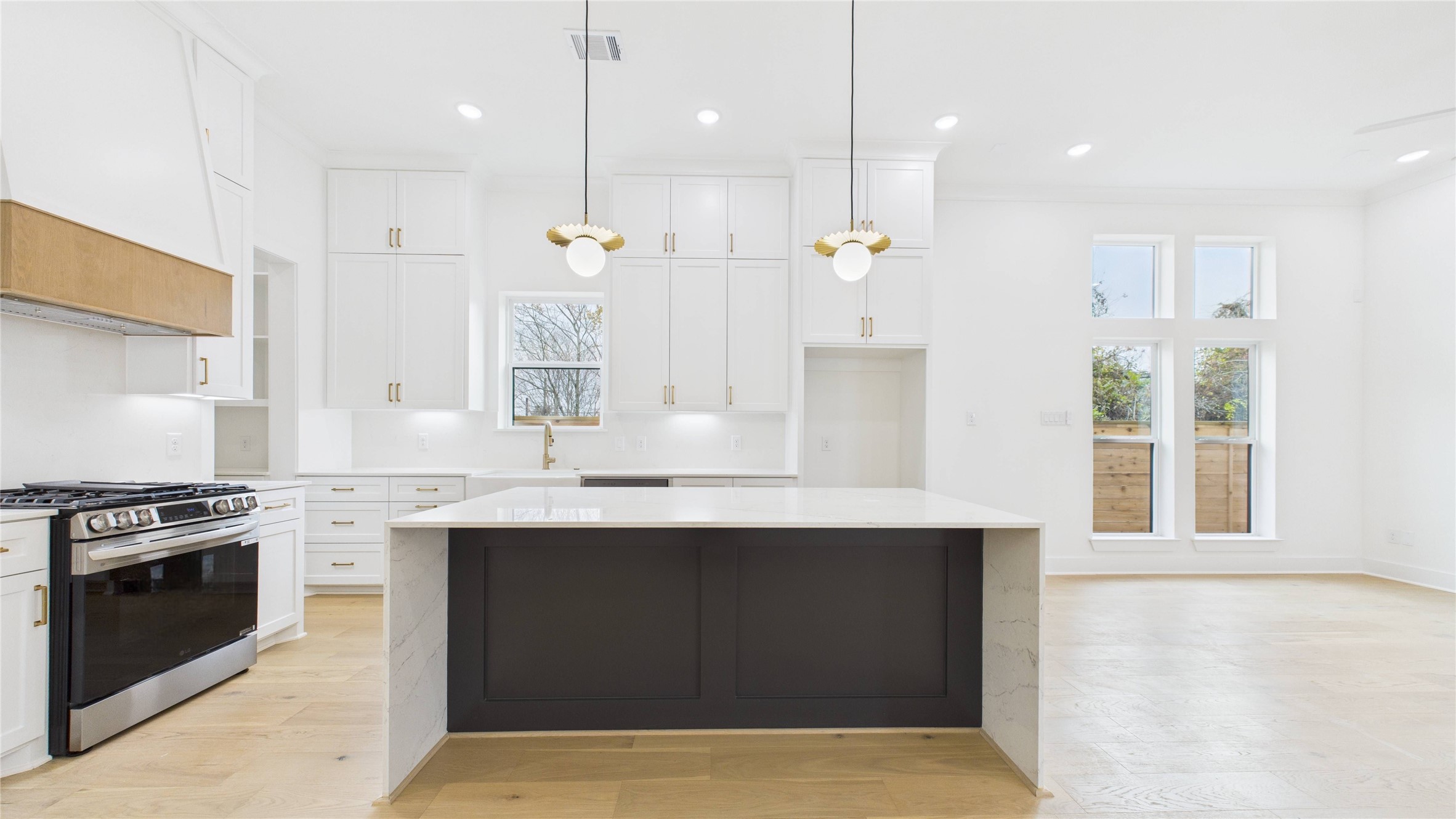 602 Jewett Street, Unit A Houston, TX 77009 - Photo 2 of 44 Grand quartz waterfall island with pop-up electrical receptor. Cabinets to the ceiling. Even the backsplash is quartz. Gold and white accents abound.