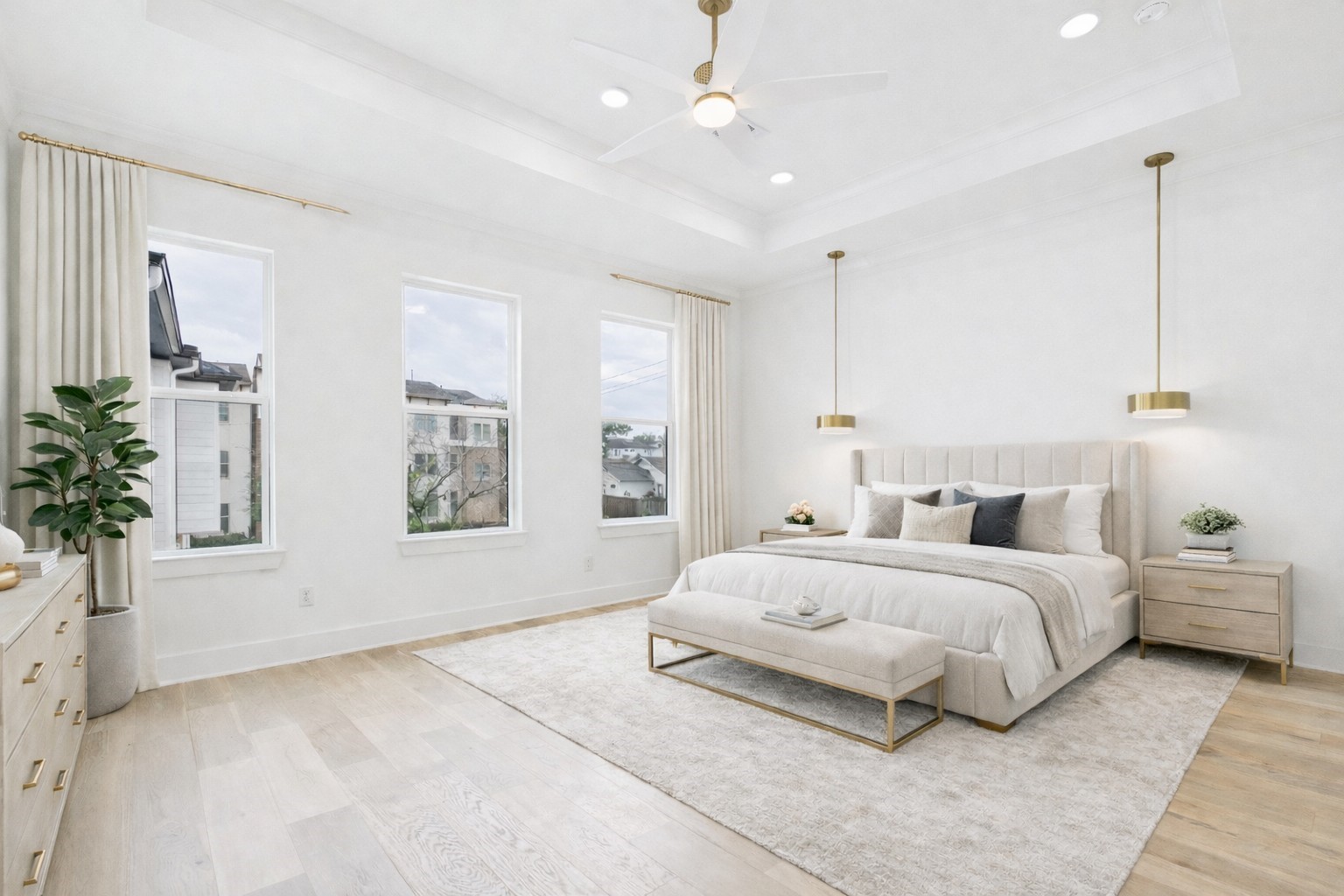 602 Jewett Street, Unit A Houston, TX 77009 - Photo 21 of 44 Bright, spacious primary bedroom room features three large windows, recessed lighting in the coffered ceiling with fan, and two modern pendant lights. Ideal for reading in bed. (Virtually staged)