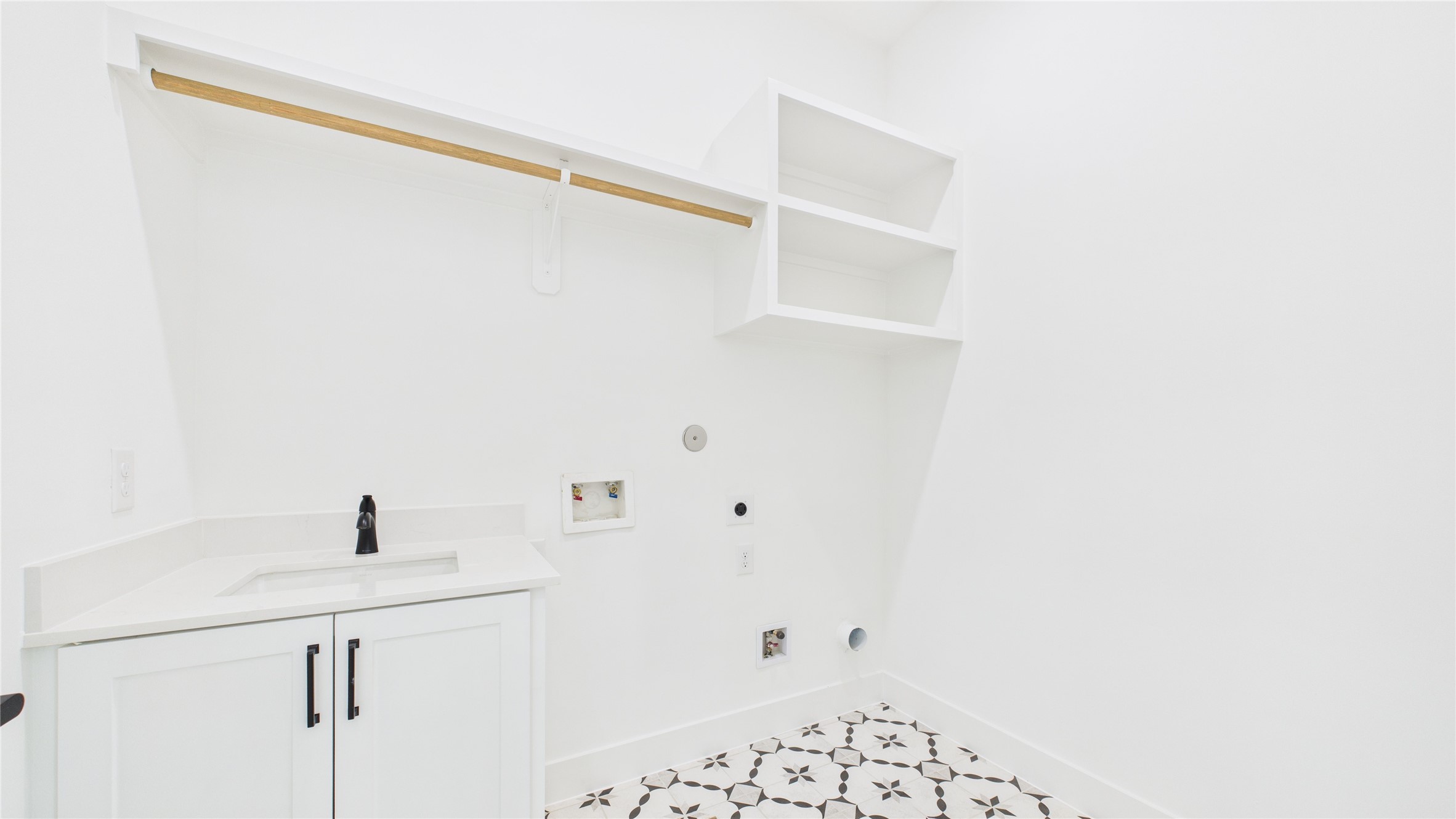 602 Jewett Street, Unit A Houston, TX 77009 - Photo 21 of 46 The second floor utility room features cabinetry, open shelving, and a patterned tile floor. It includes a space for a washer and dryer and ample storage.