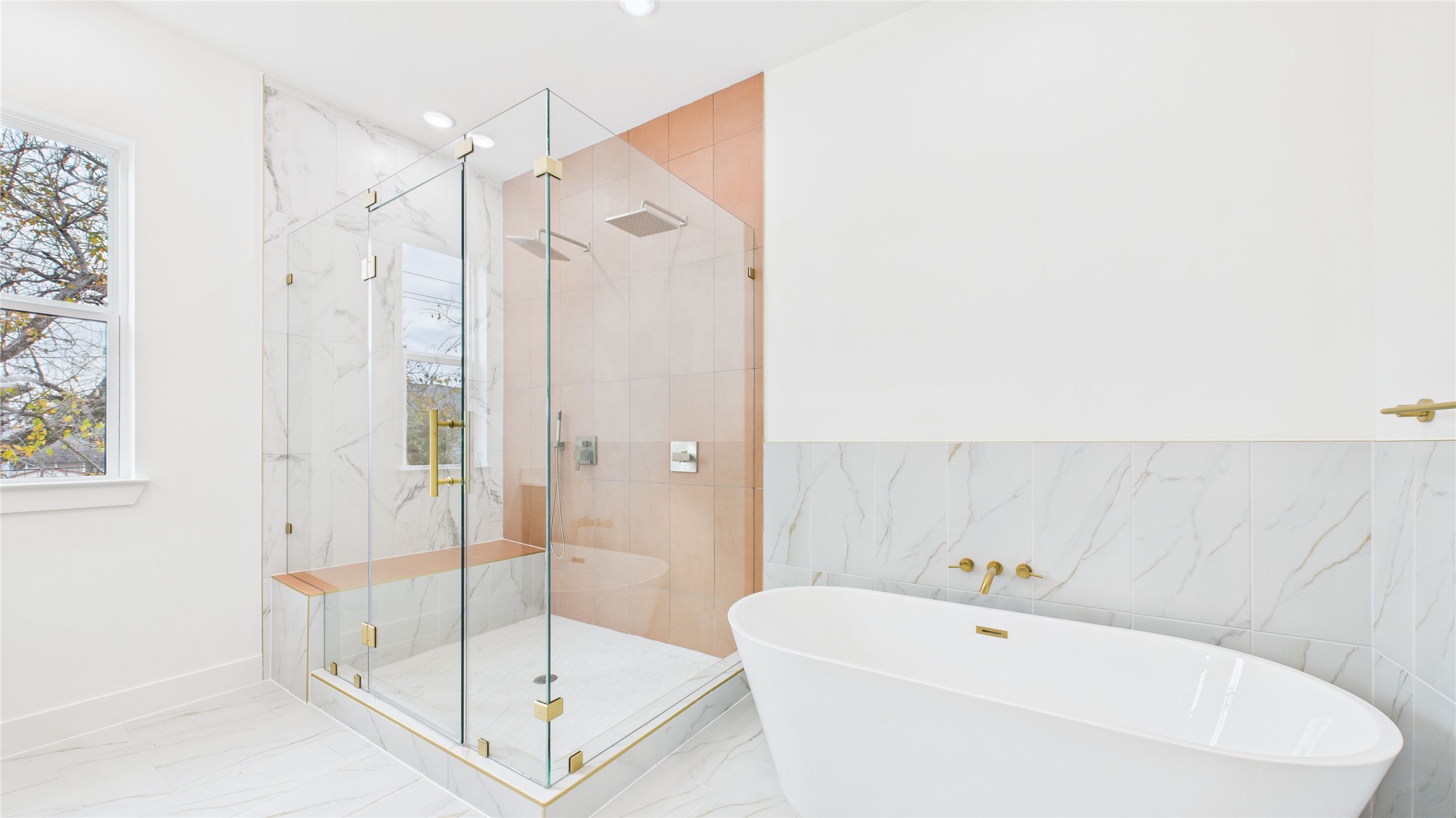 602 Jewett Street, Unit A Houston, TX 77009 - Photo 32 of 46 Natural light streams in through a large window, creating a bright and inviting space, accented by sleek fixtures and white tiles. Extra large soaking tub.