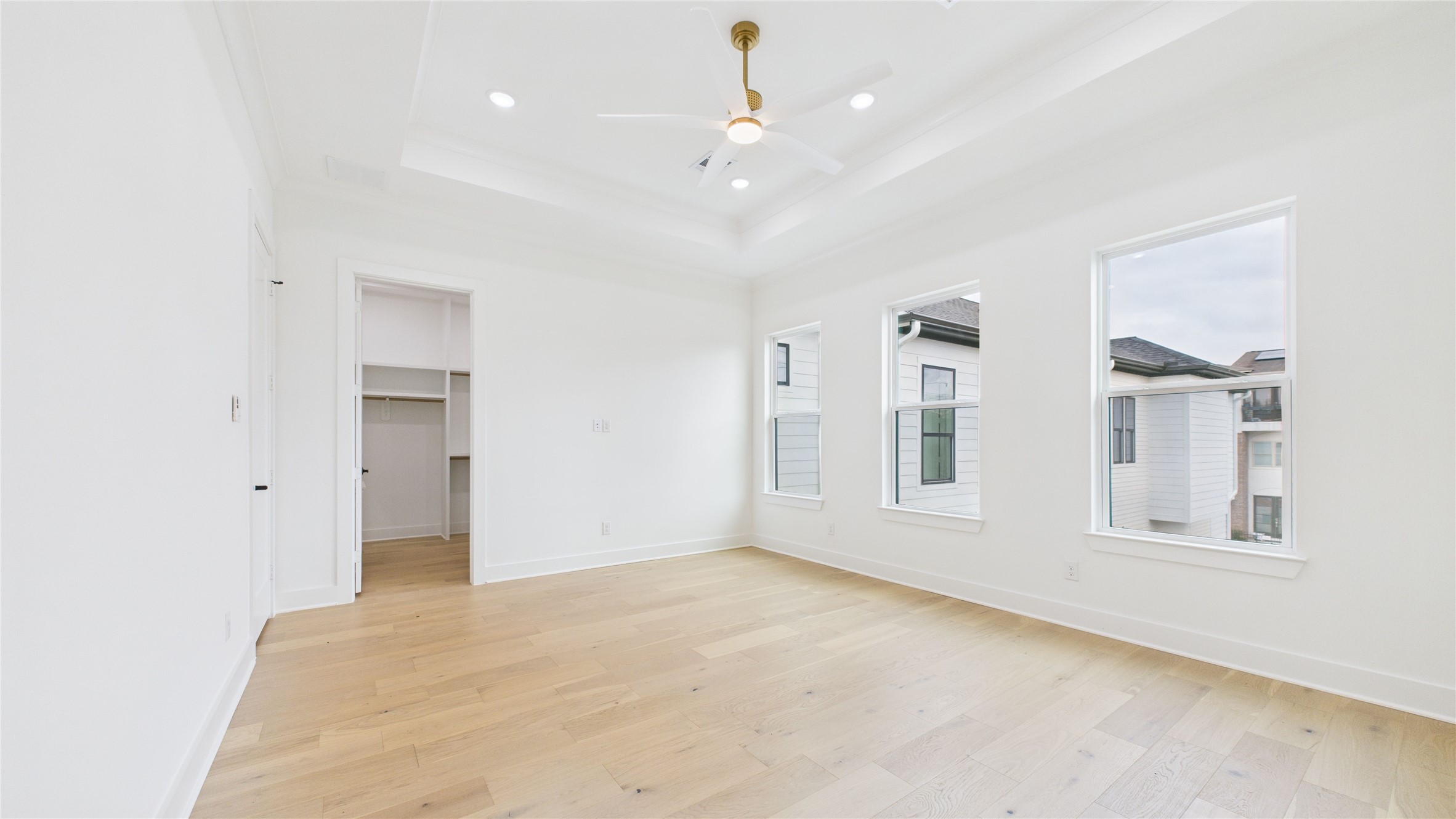 602 Jewett Street, Unit A Houston, TX 77009 - Photo 34 of 44 Secondary bedroom with three large windows allow plenty of natural light. There's an open doorway leading to a walk-in closet.