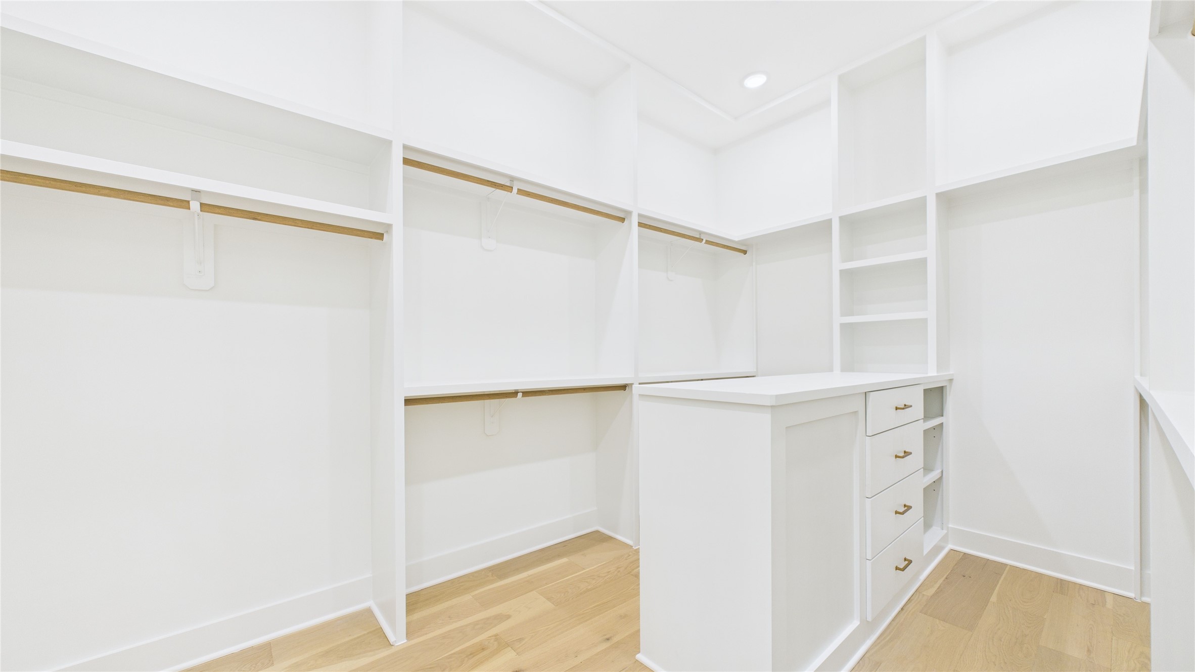 602 Jewett Street, Unit A Houston, TX 77009 - Photo 34 of 46 Very spacious, well-lit walk-in primary closet with ample shelving and hanging space, featuring a central island with drawers.