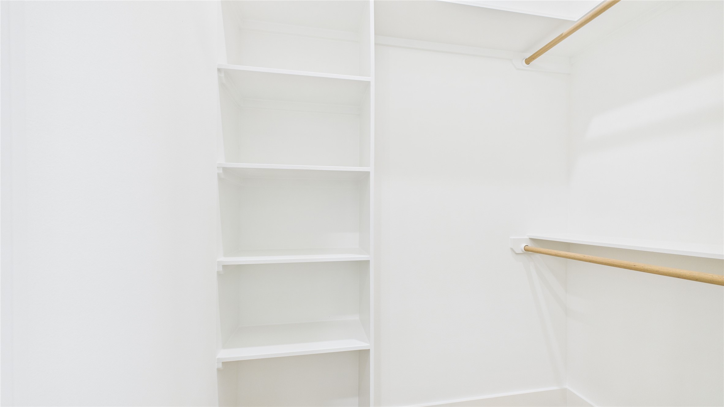 602 Jewett Street, Unit A Houston, TX 77009 - Photo 42 of 46 This is a spacious, bright walk-in closet featuring multiple shelves and hanging rods, perfect for organized storage.