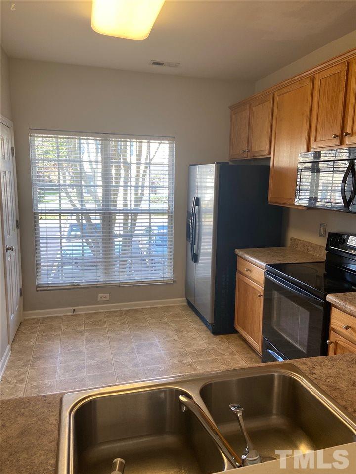 3048 Settle In Lane Raleigh, NC 27614 - Photo 2 of 5 a kitchen with a sink and a refrigerator