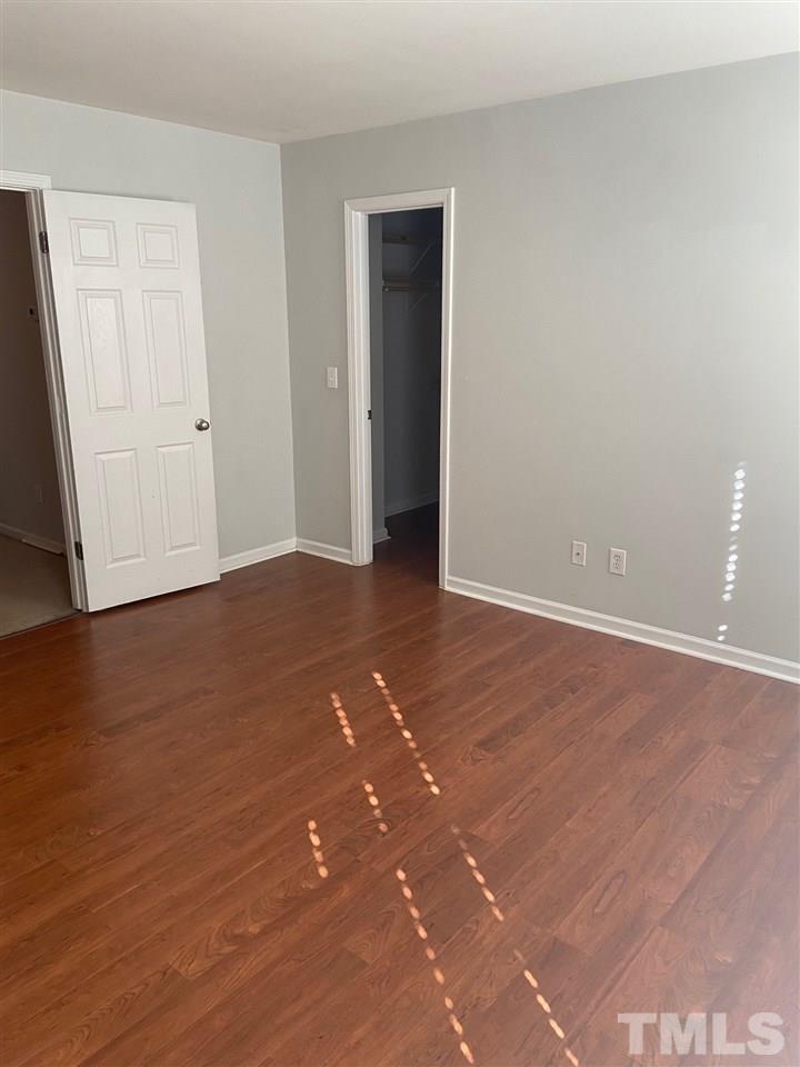 3048 Settle In Lane Raleigh, NC 27614 - Photo 3 of 5 an empty room with wooden floor and closet